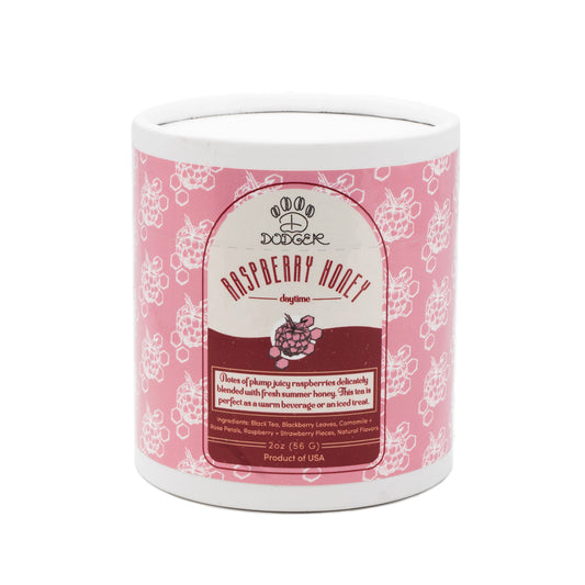 Raspberry Honey dodger daytime tea packaging. Notes of plump juicy raspberries delicately blended with fresh summer honey. This tea is perect as a warm beverage or an iced treat.