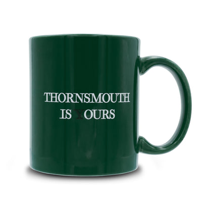 Green mug that reads thornsmouth is your's the Y is black
