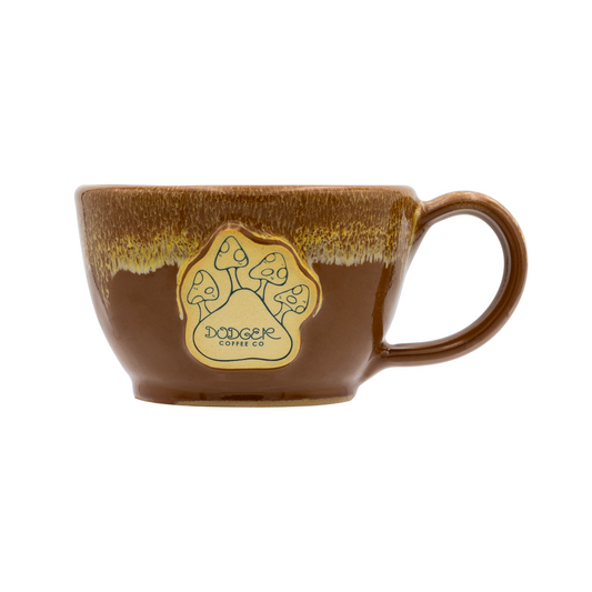 Brown ceramic mug with a logo on a white background